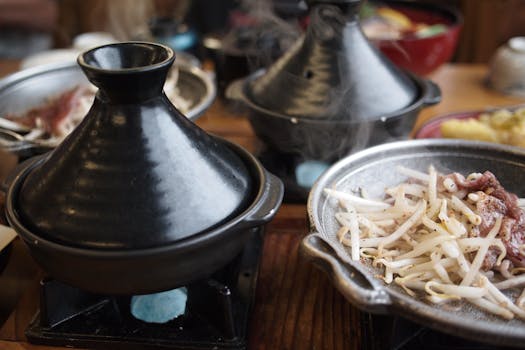 Delicious bean sprouts served in a traditional cookware setup for a warm dining experience.