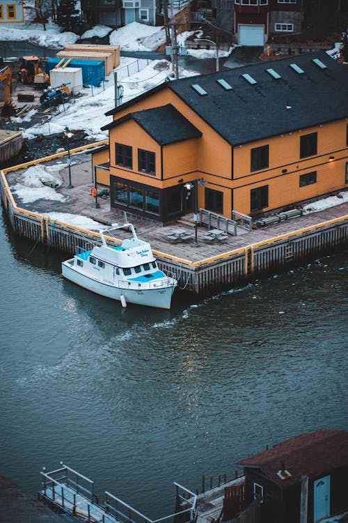 White Boat on Dock Near Houses