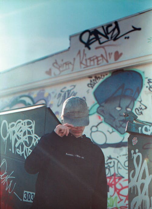 Man in Black Crew Neck Shirt Wearing Gray Hat