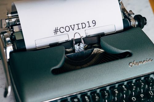 Free Close-up of a vintage typewriter with COVID-19 text. Conceptual image of pandemic communication. Stock Photo