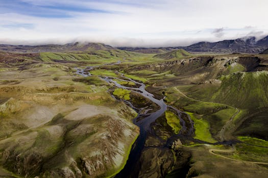 A breathtaking aerial shot capturing the vast, lush landscapes of Iceland's highlands.