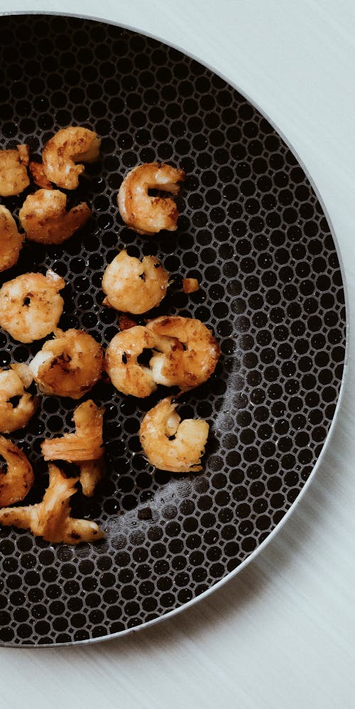 Overhead Shot of Fried Shrimps on a Black Plate