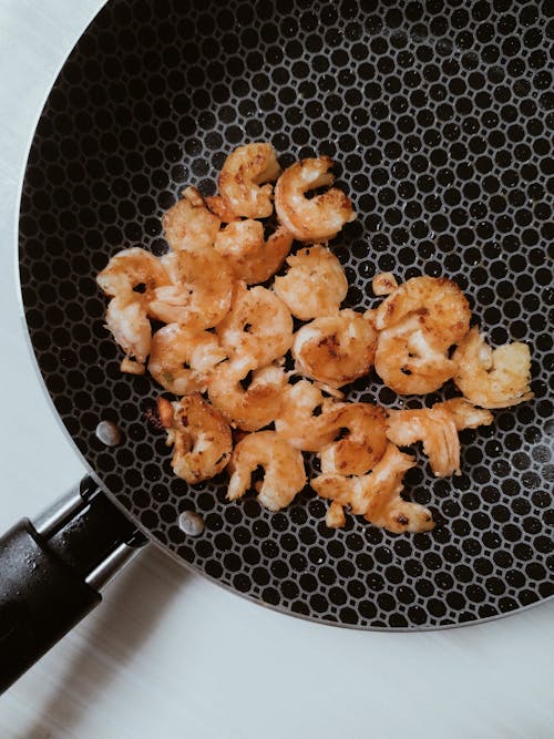 Close-Up Photo of Fried Shrimps on a Black Pan