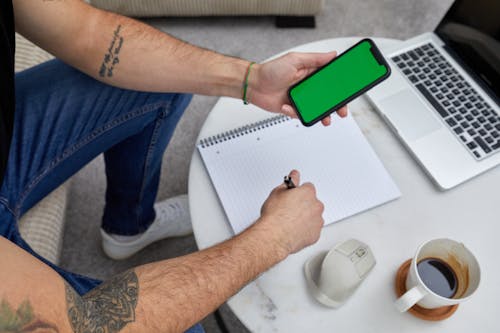 Male Arms Holding Cellphone with Green Screen