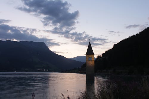 Reschensee Lake with Sumberged Church Bell Tower at Dusk, South Tyrol, Italy