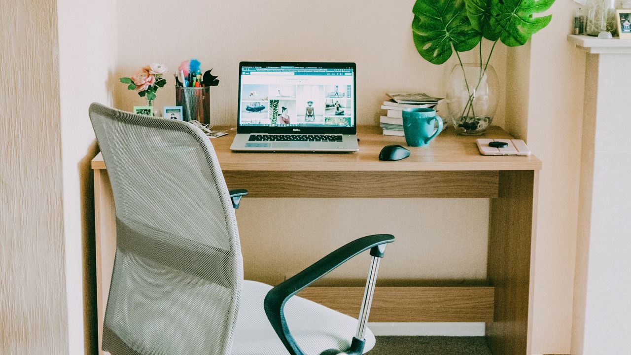 Minimalist distraction free home office Bright minimalist home office with desk chair and laptop for focused work