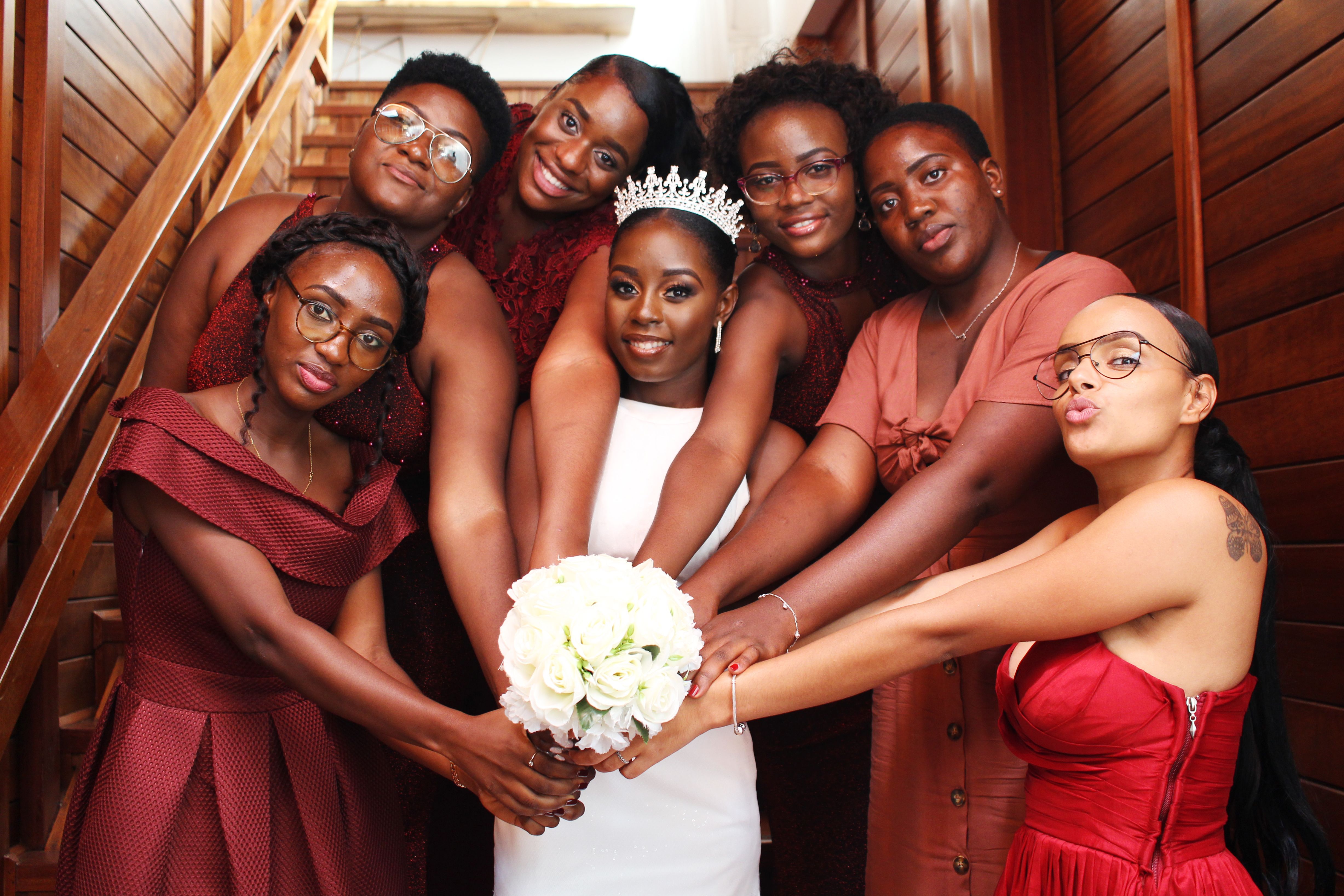 Bride with her bridesmaids, showcasing a mix of love and elegance in a beautifully staged pose.