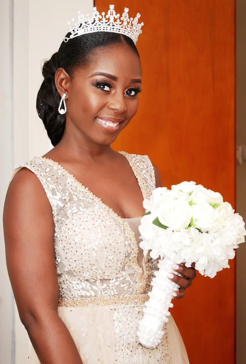 Free Woman in White Floral Sleeveless Dress Holding Bouquet of White Roses Stock Photo