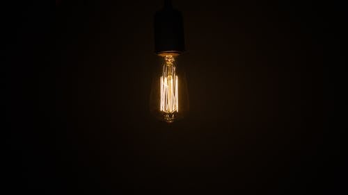 Free White Light Bulb Turned on in Dim Lit Room Stock Photo