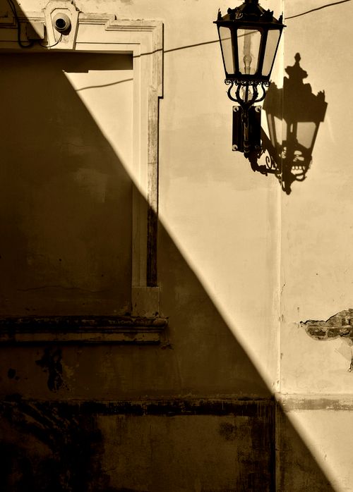 Free A vintage street lamp casts dramatic shadows on a wall in Lviv, Ukraine. Stock Photo