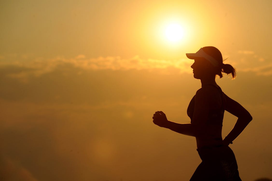 Woman running in the sunrise