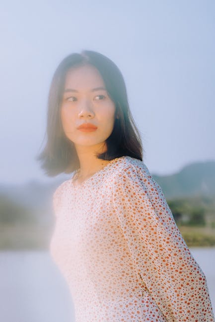 A serene portrait of a woman in Vietnam, captured outdoors with a soft dreamy effect.