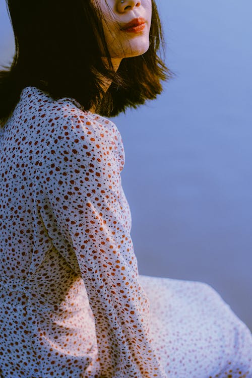 Woman in White and Red Floral Long Sleeve Shirt