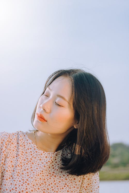 Woman in Orange and White Floral Shirt