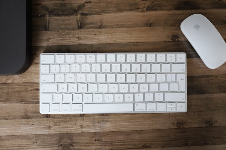 White Keyboard And Computer Mouse On Table