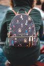 Person in Green Jacket Wearing Michael Kors Backpack