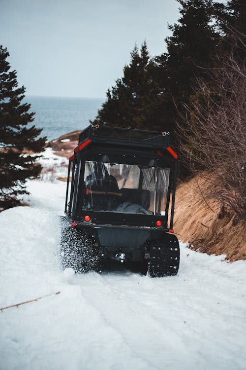 Black Vehicle on Snow Covered Ground