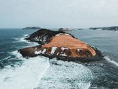 Brown Rock Formation on Sea
