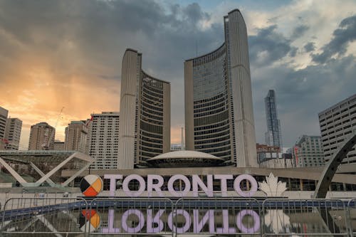Free Toronto Signage Near Buildings Under White Clouds Stock Photo