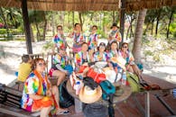 Group of People Sitting on Brown Wooden Bench