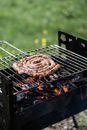 Brown Sausage on Black Metal Grill