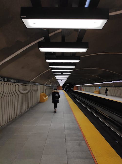 Person Standing on the Platform Waiting for the Train