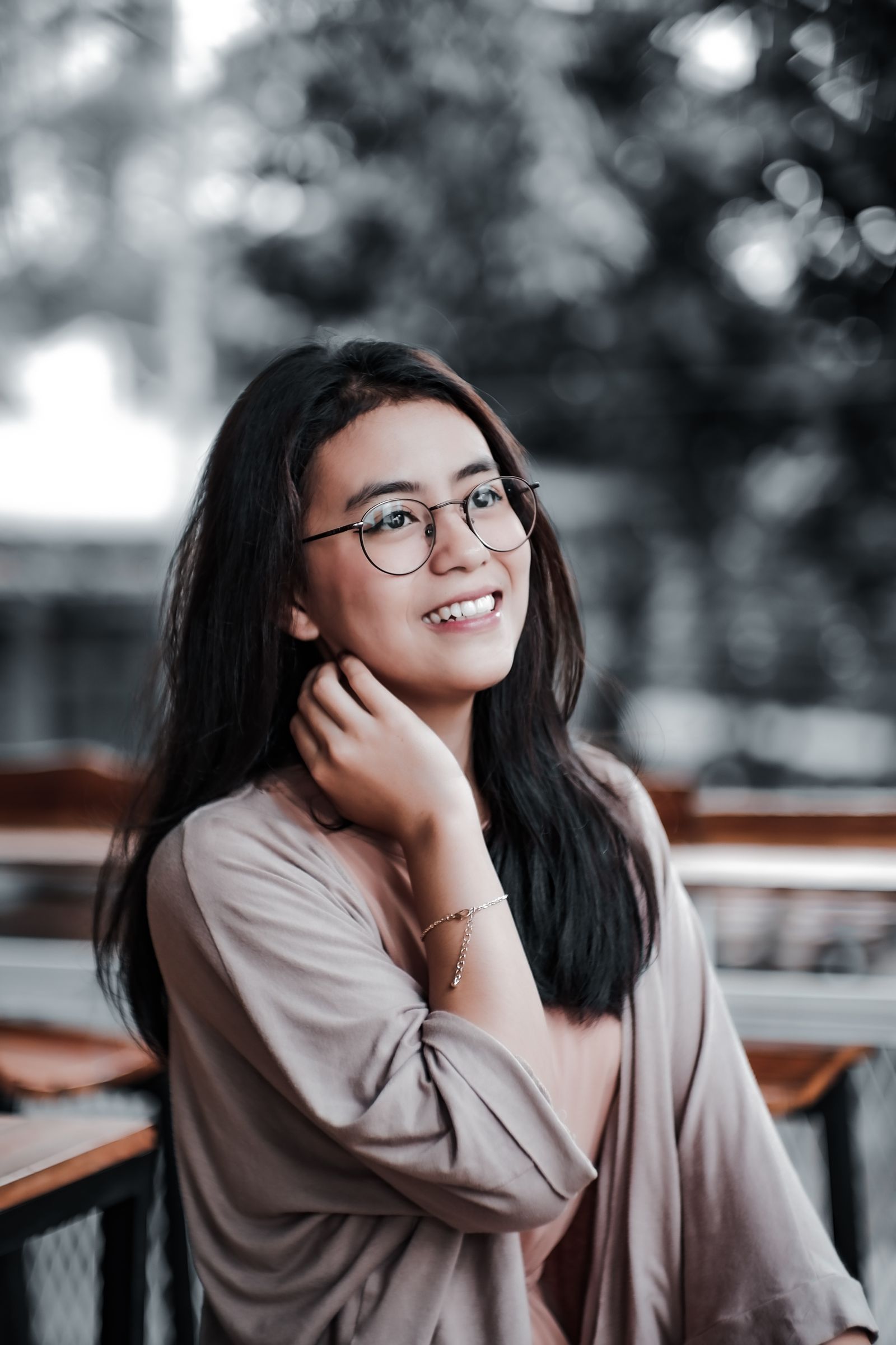 Woman in black-framed glasses smiling