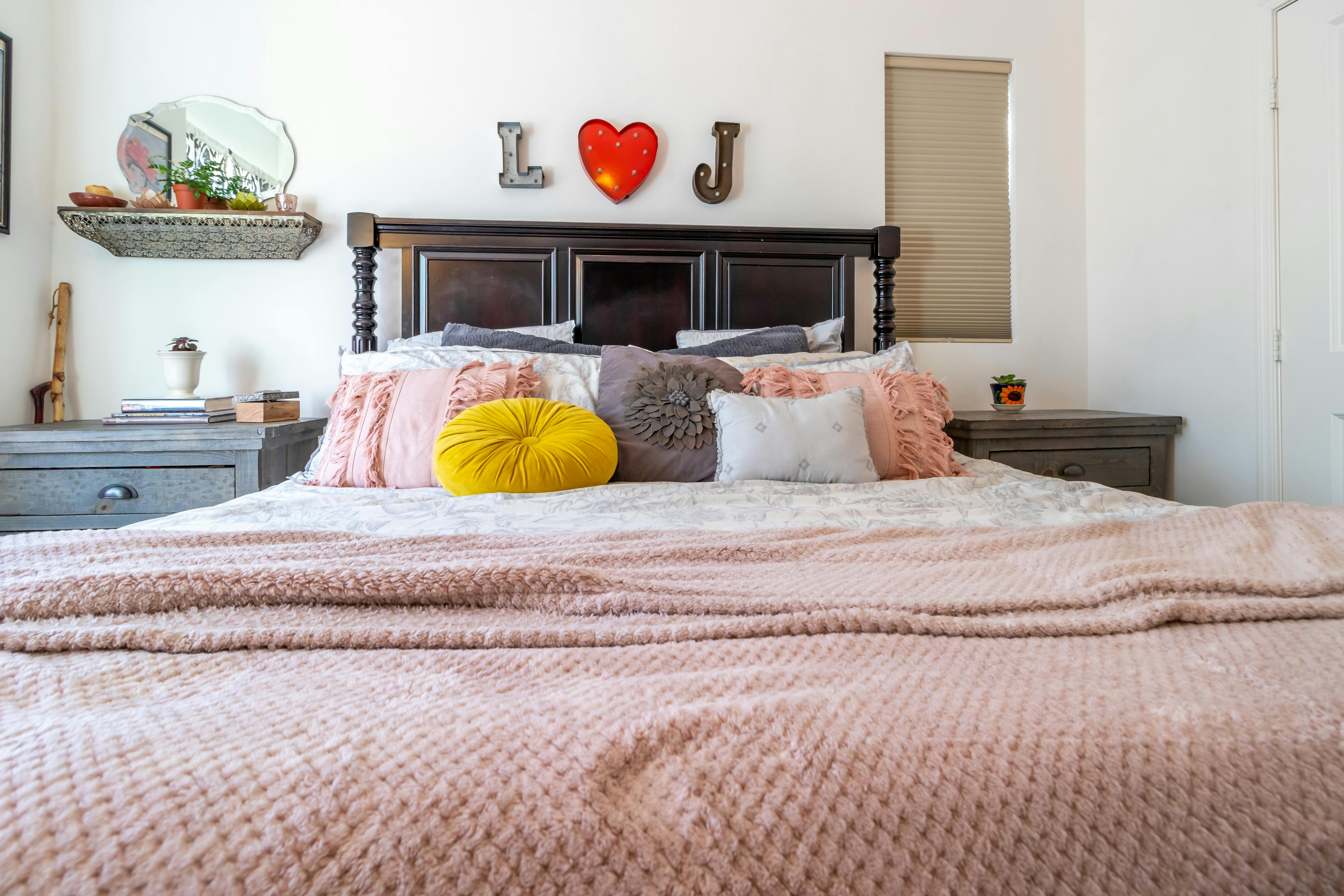 Large bed with pillows in middle of bedroom · Free Stock Photo