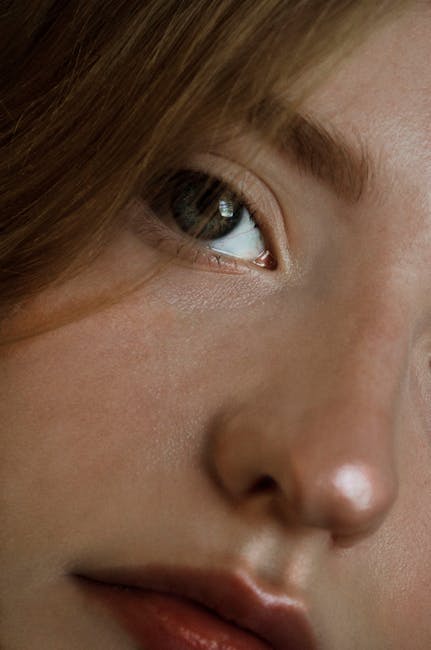 Intimate close-up of a woman's face highlighting vibrant eye and natural features.