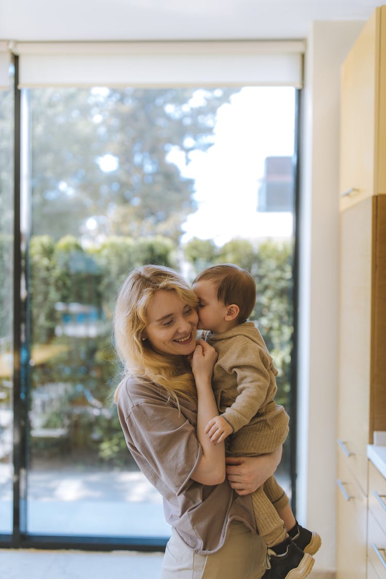 Baby Boy Giving A Kiss To His Mother