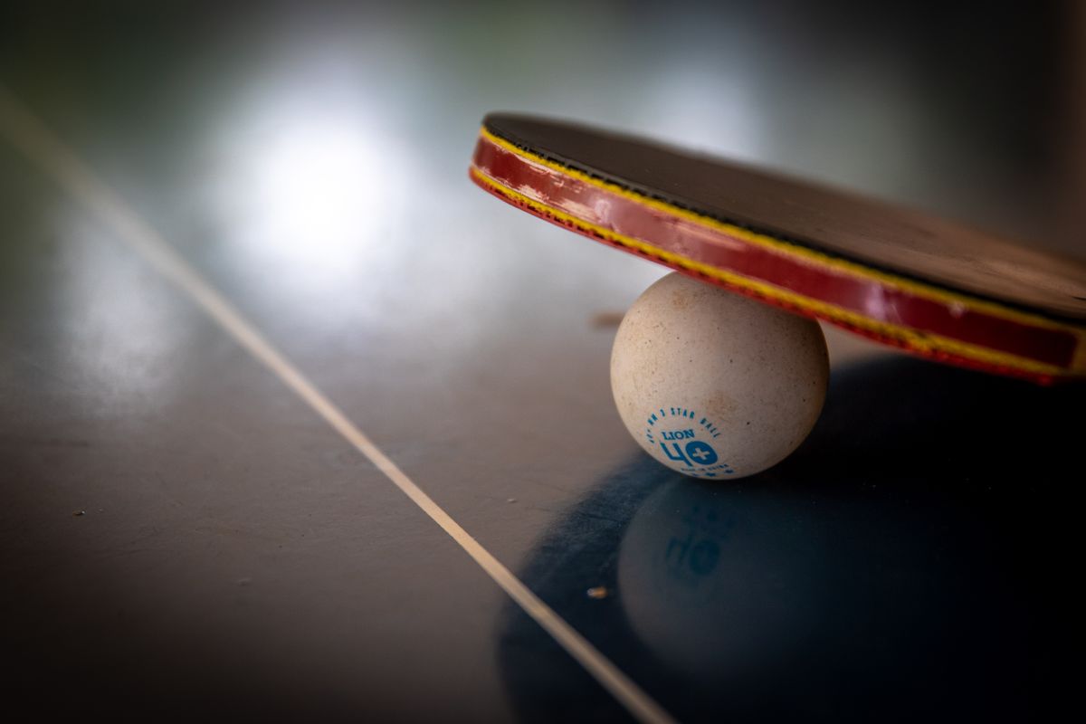 Ping pong ball and racket on a table