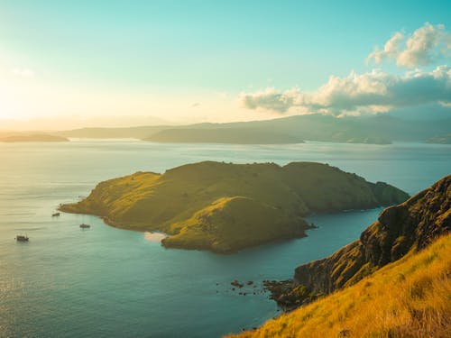 Green and Brown Island Under Blue Sky