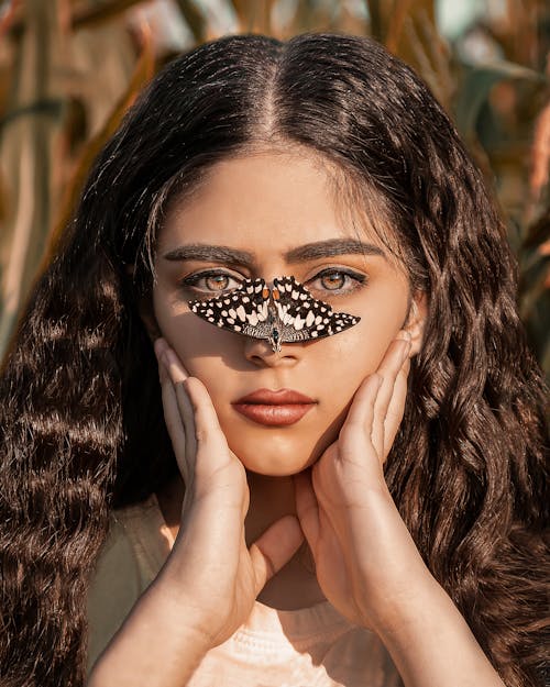 Beautiful Woman with Butterfly on Her Nose