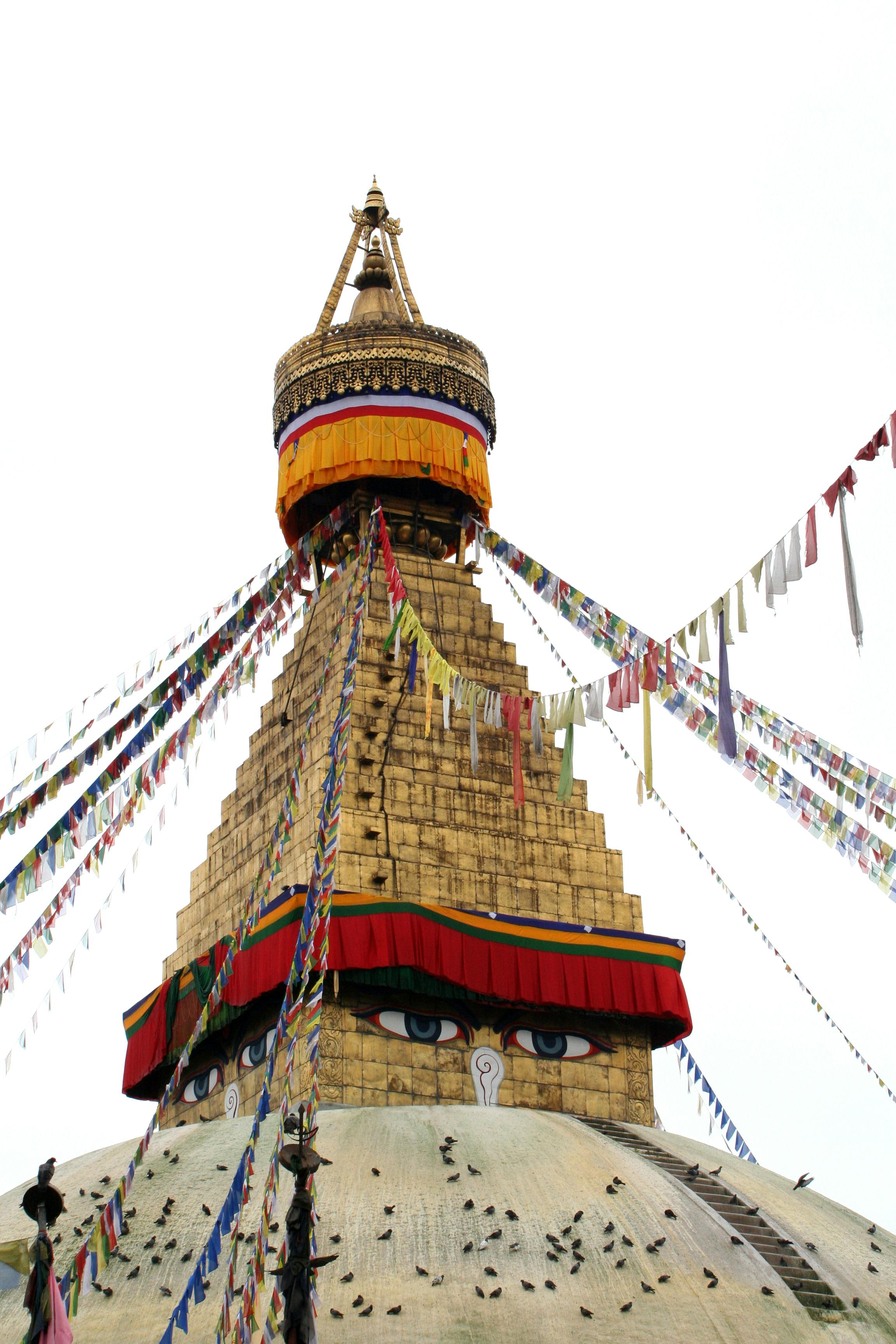 Iconic Boudhanath Stupa in Nepal with colorful prayer flags. A symbol of Buddhist spirituality.