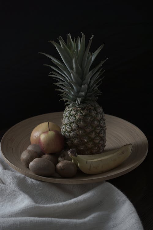 Pineapple Fruit on Brown Wooden Round Plate