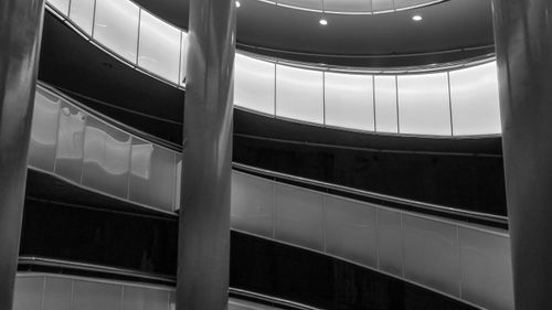 Free Artistic view of a spiral staircase with modern architectural elements. Stock Photo