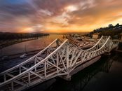 White Metal Bridge over River during Sunset