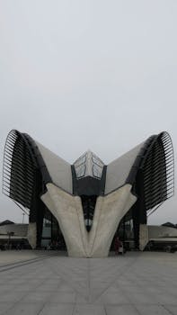 Striking modern design of Lyon-Saint Exupery Airport's terminal, showcasing unique curves and forms.