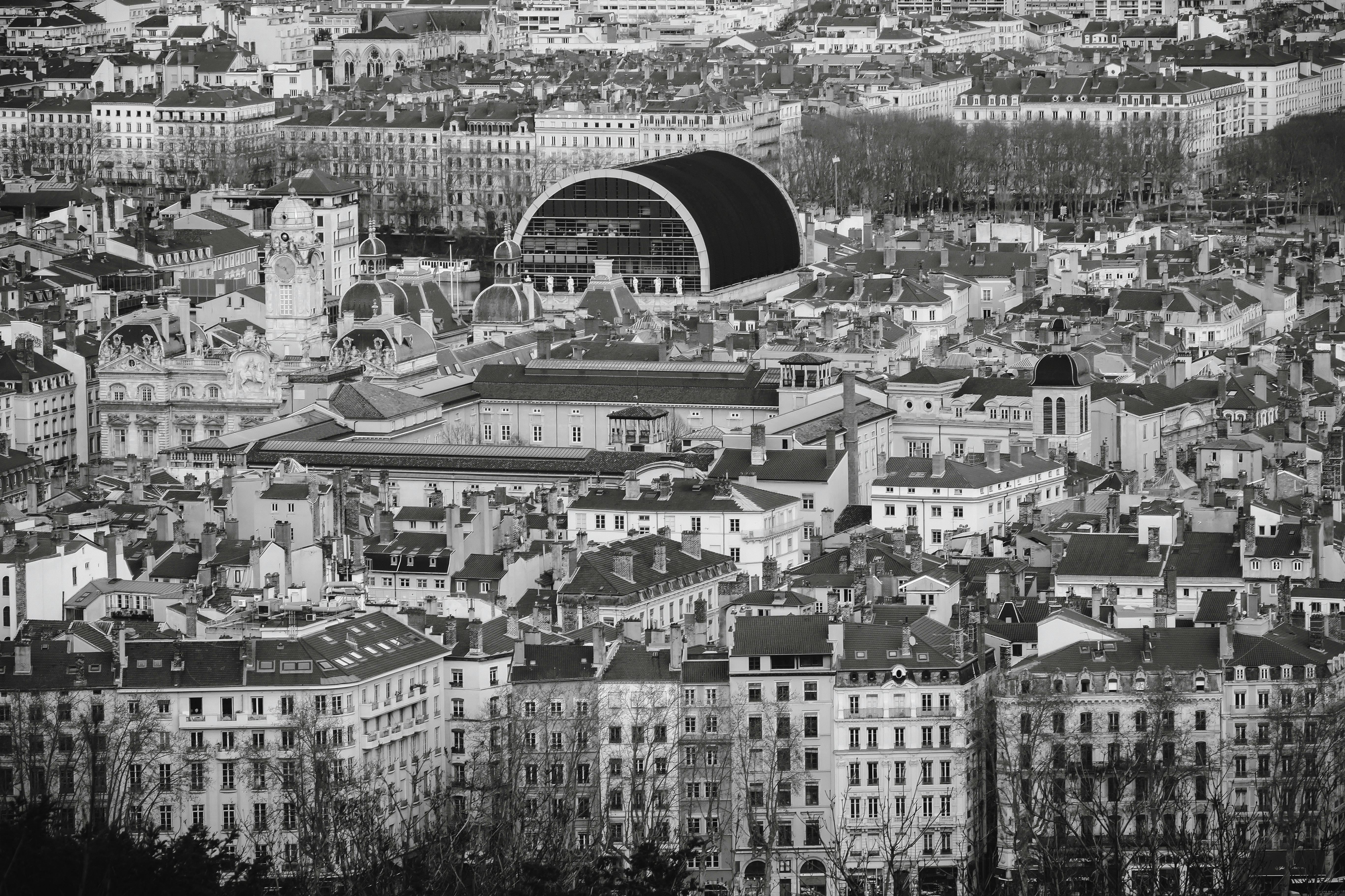 grayscale photo of opera nouvel amidst city buildings in lyon france