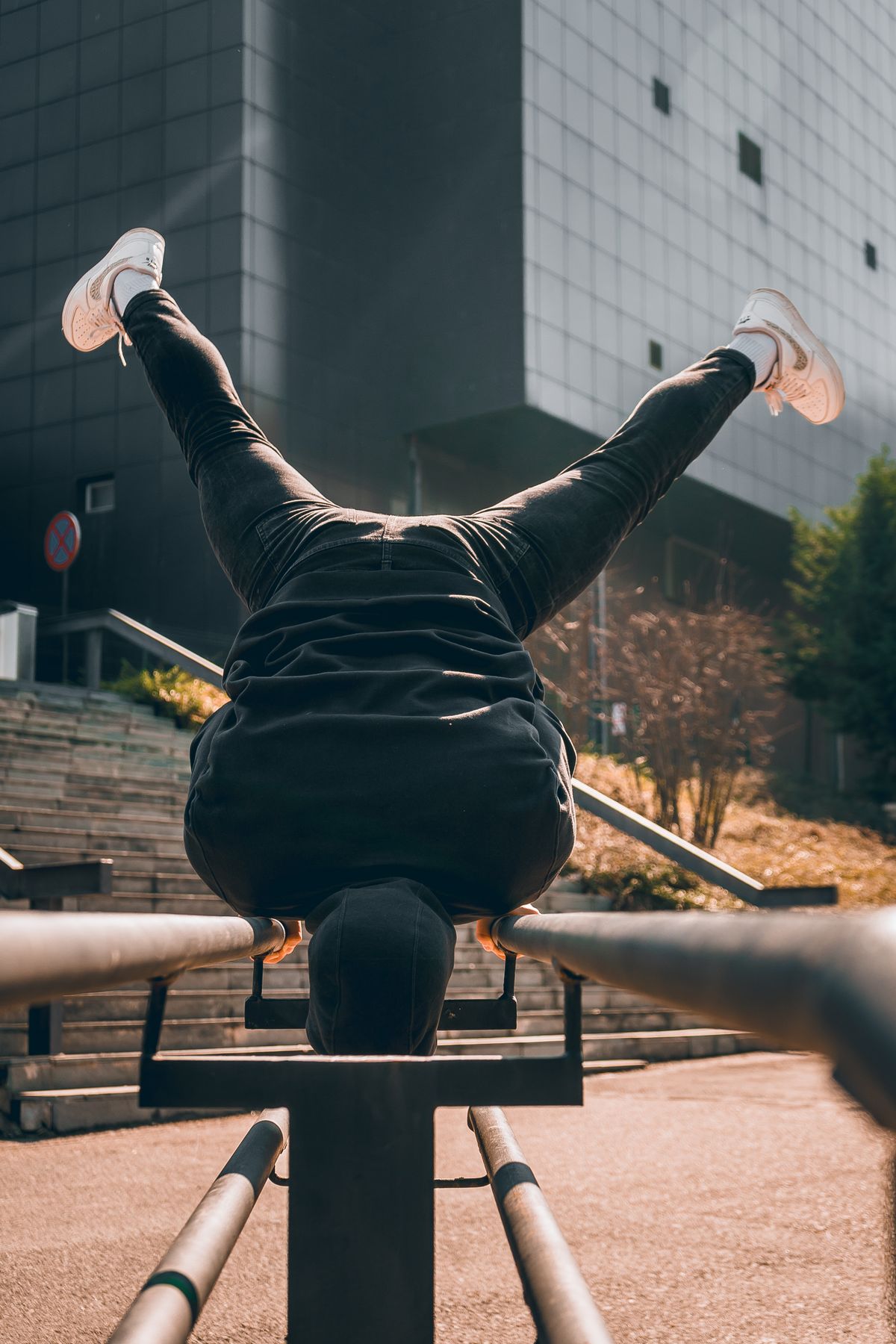 Man doing push-ups during an outdoor workout in a city park