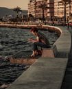 Person Sitting on Concrete Dock