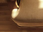 棕色布艺沙发沐浴在温暖的阳光下，在室内投下阴影