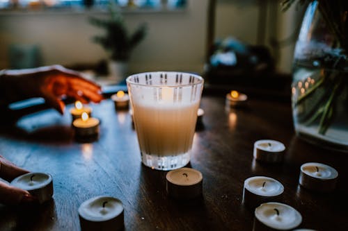 Lighted Candles on Brown Wooden Table