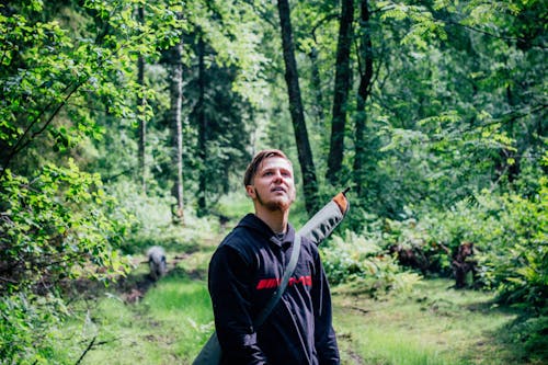 Man in Black Sweater in the Middle of the Forest