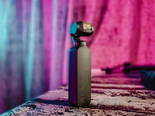 Free Dji Osmo Pocket on Brown Wooden Table Stock Photo