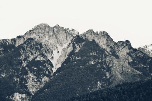 Free Black and white picturesque view of rocky mountains with steep cliffs under gloomy sky Stock Photo