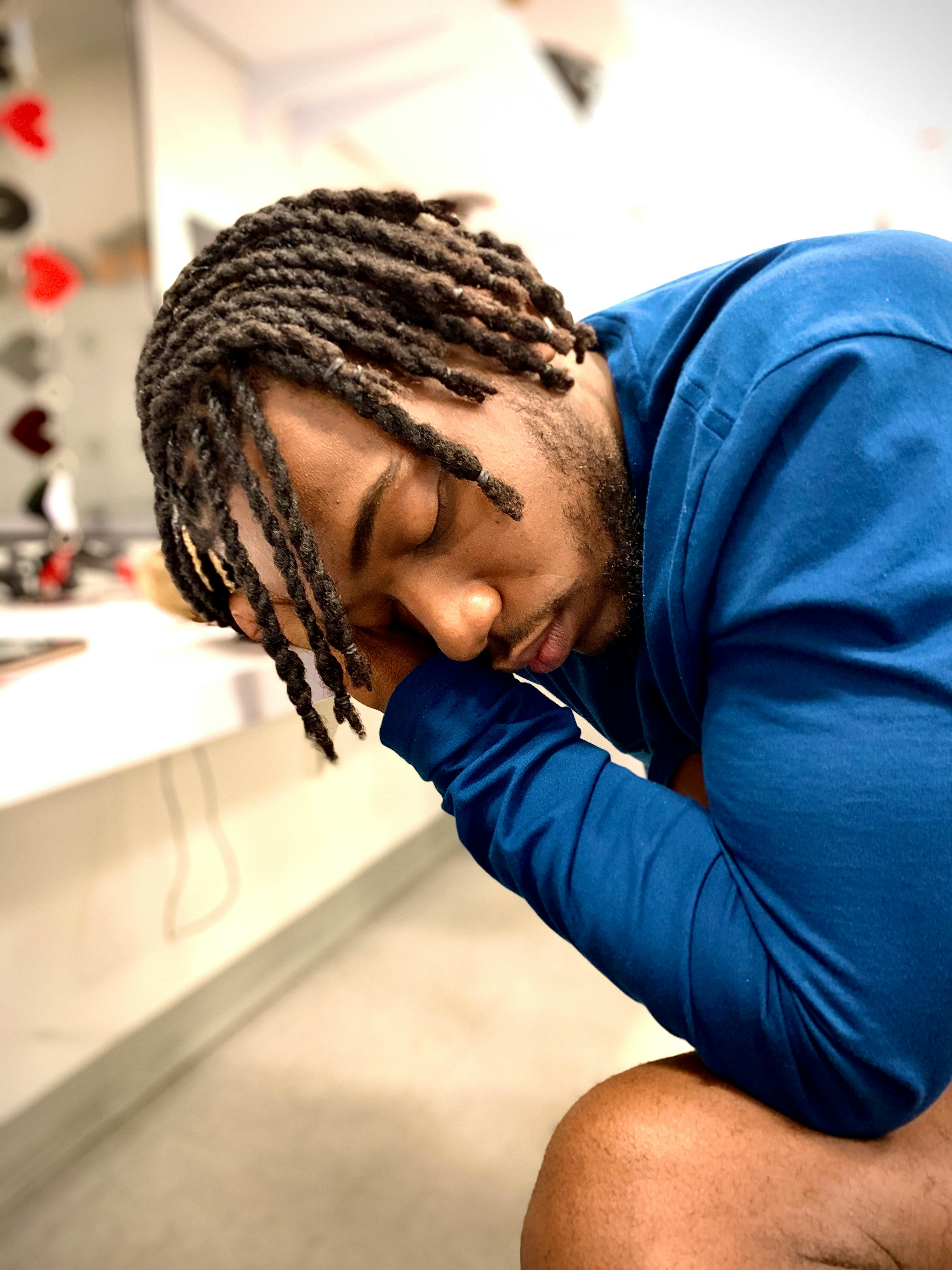 Black Man With Dreadlocks Sitting With Eyes Closed Free Stock Photo