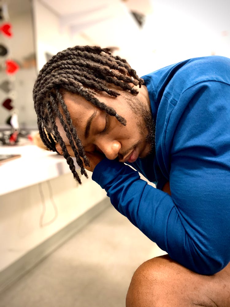 Black Man With Dreadlocks Sitting With Eyes Closed