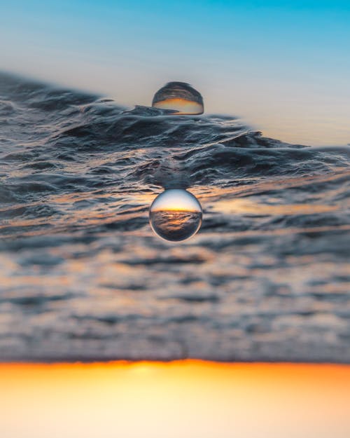 Upside Down Photo of Glass Ball on Water