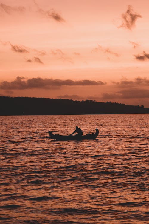 Free Silhouette of Person Riding on Boat during Sunset Stock Photo